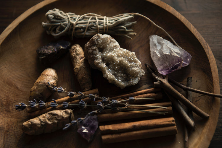 wooden bowl full of crystals, herbs and spices. 