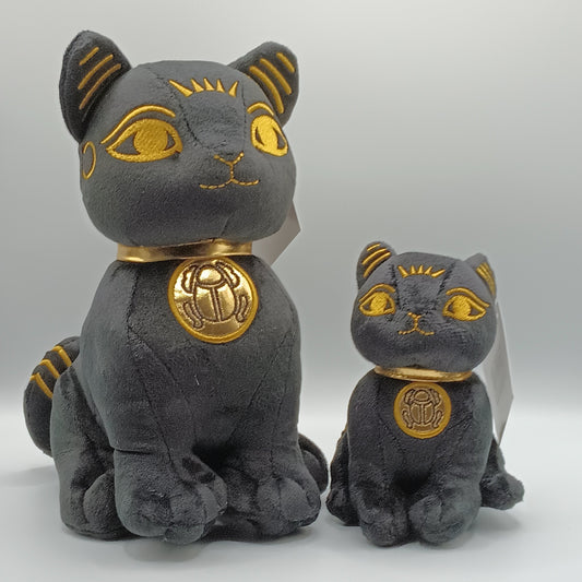 Two plush cat toys with gold accents on a white background