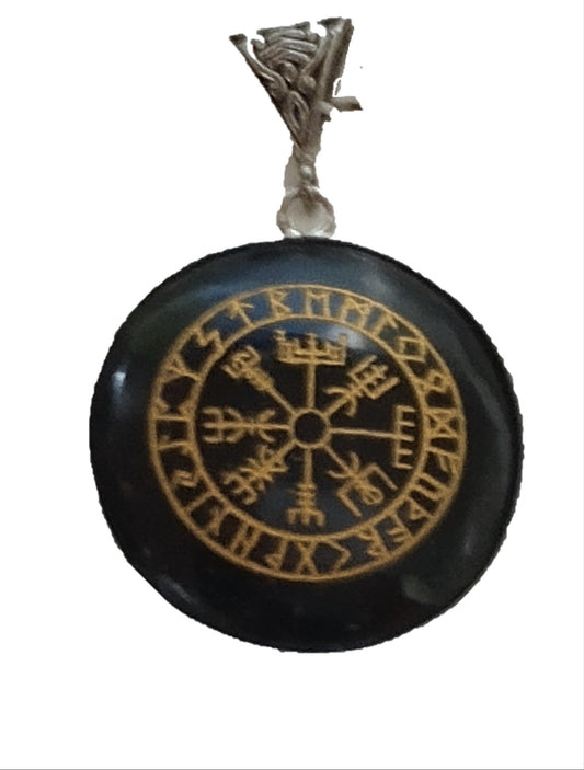 Black pendant with gold Runes and silver chain on a white background